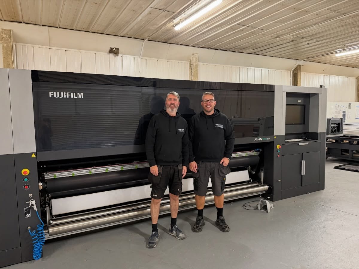 Spectra Service Solutions engineers in front of a Fujifilm Acuity wide format printer